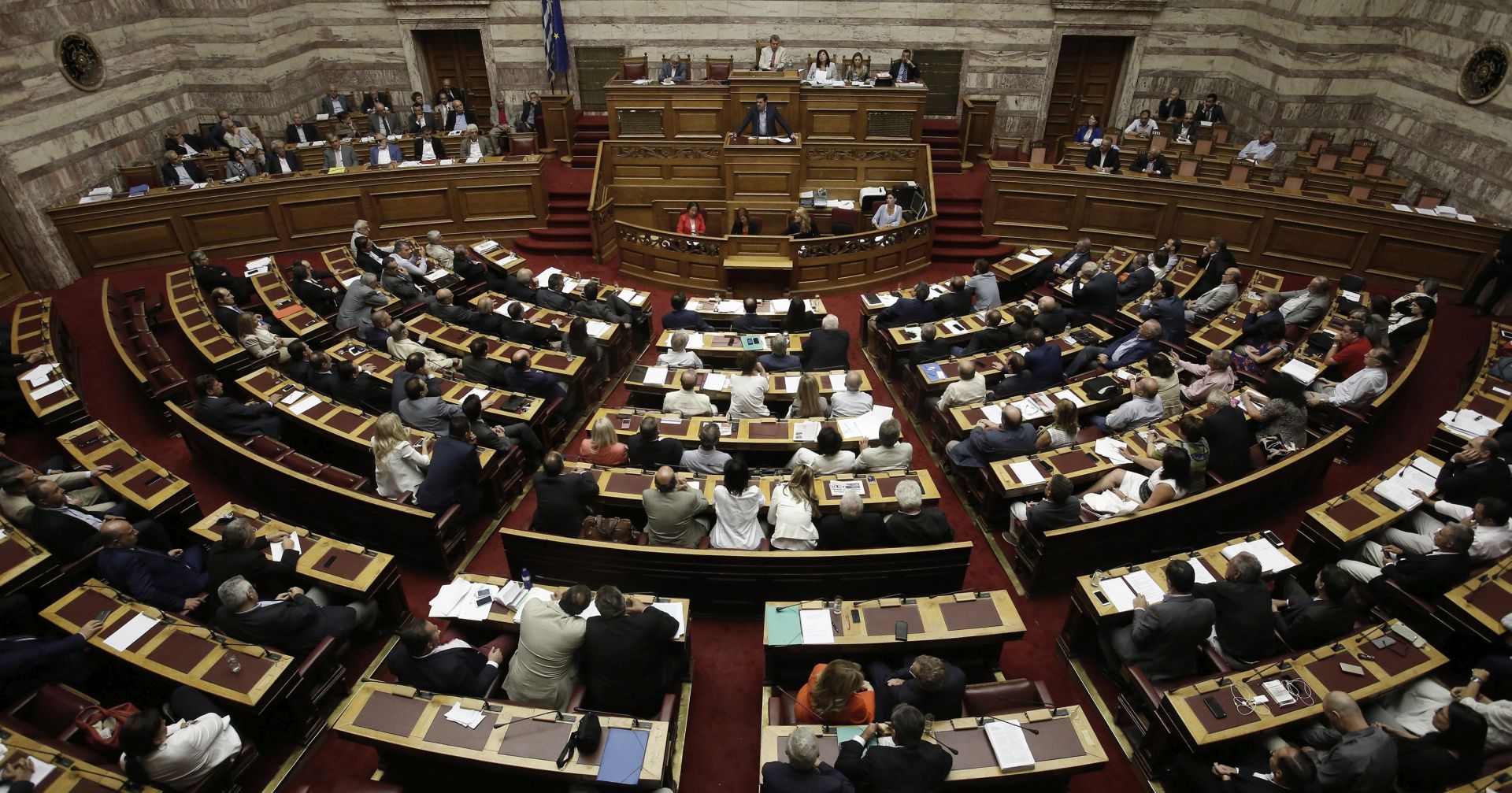 epa04857086 Greek Prime Minister Alexis Tsipras (C) delivers his speech during a parliamentary session in Athens, Greece 22 July 2015. Greece and its creditors kicked off new bailout negotiations with the aim of reaching a deal by mid-August, as the Greek Parliament prepared to vote on a second batch of reforms promised in exchange for the international aid.  EPA/Yannis Kolesidis