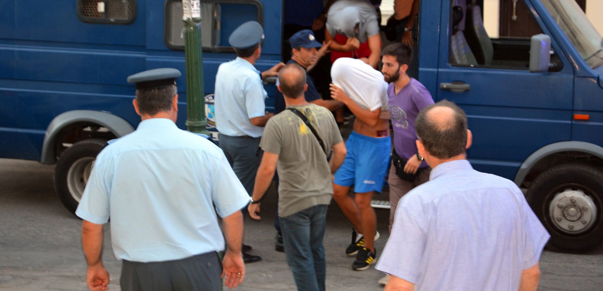 epa06077550 Suspects, (with their heads covered) are escorted to the prosecutor’s office by Greek police, on the island of Zakyntho, Greece, 09 July 2017, in connection to the killing of a 22-year-old US tourist who was beaten to death on 07 July 2017 outside a bar in the tourist resort of  Laganas, on the island of Zakynthos. Policemen arrested six Serbian nationals, a 34-year-old Greek and a 32-year-old British national of Serbian descent for allegedly participating in the same incident.  EPA/STR