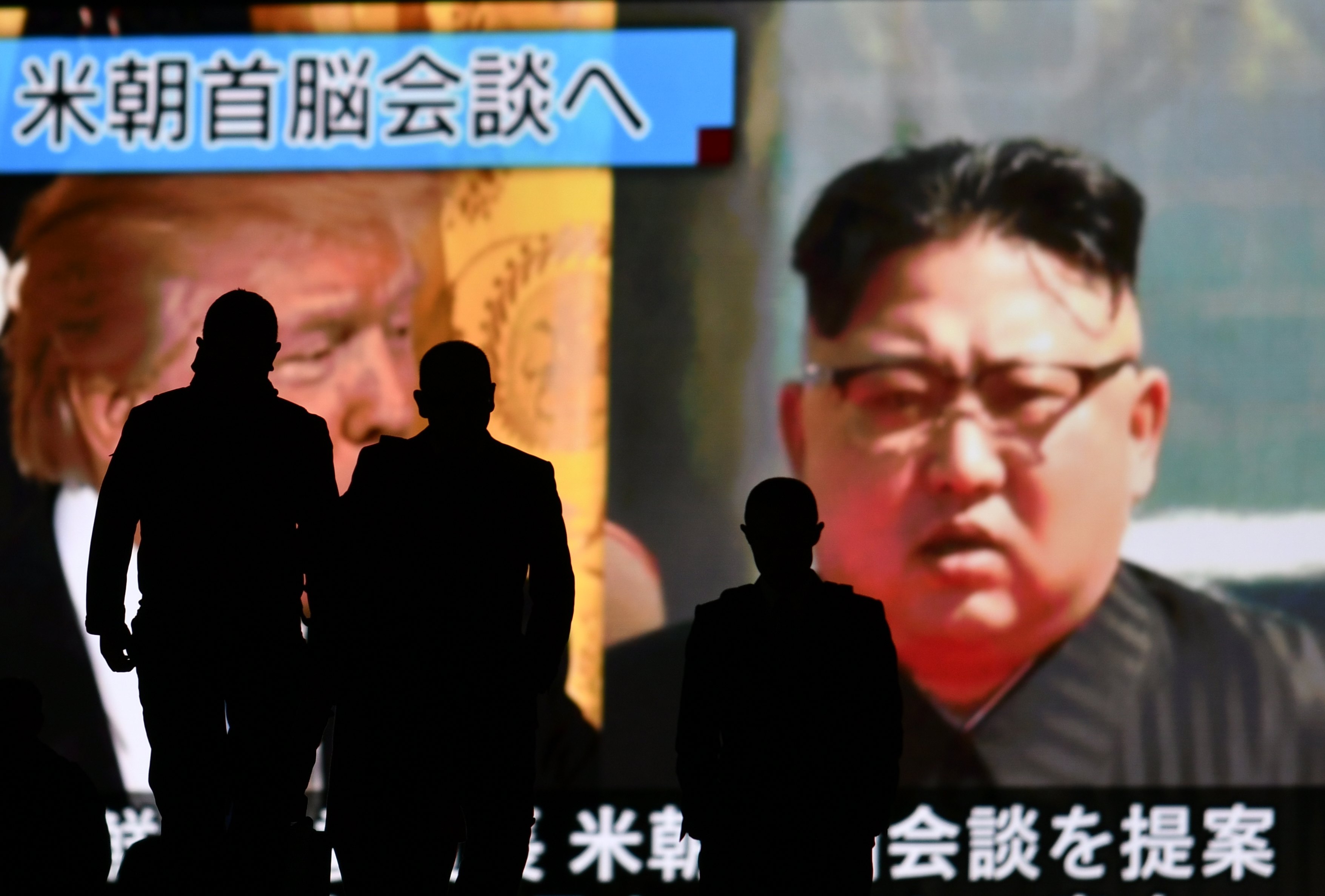 epa06591260 Passerby walk before a large screen showing archive footage of US President Donald J. Trump (L) and North Korean leader Kim Jong-un (R) in Tokyo, Japan, 09 March 2018. Earlier in the day, North Korean leader Kim Jong-un has agreed to meet US President Donald J. Trump by May for a first-ever bilateral summit.  EPA/FRANCK ROBICHON