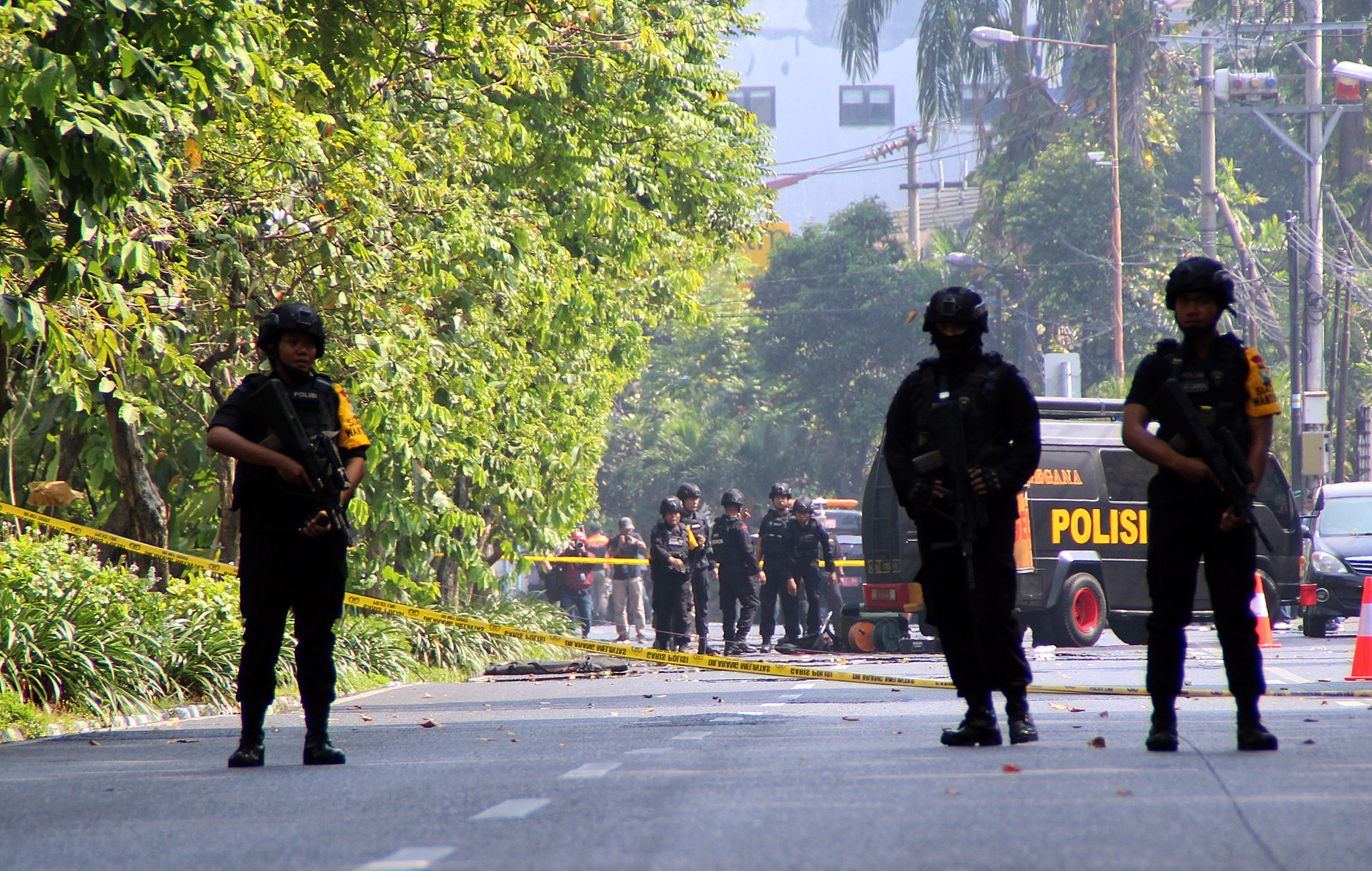 epa06732363 Indonesian bomb squad police officers inspect a blast site in front of a church in Surabaya, East Java, Indonesia, 13 May 2018. According to media reports, at least three people have been killed and dozens others injured after bomb blasts occurred at three locations in Surabaya.  EPA/STR