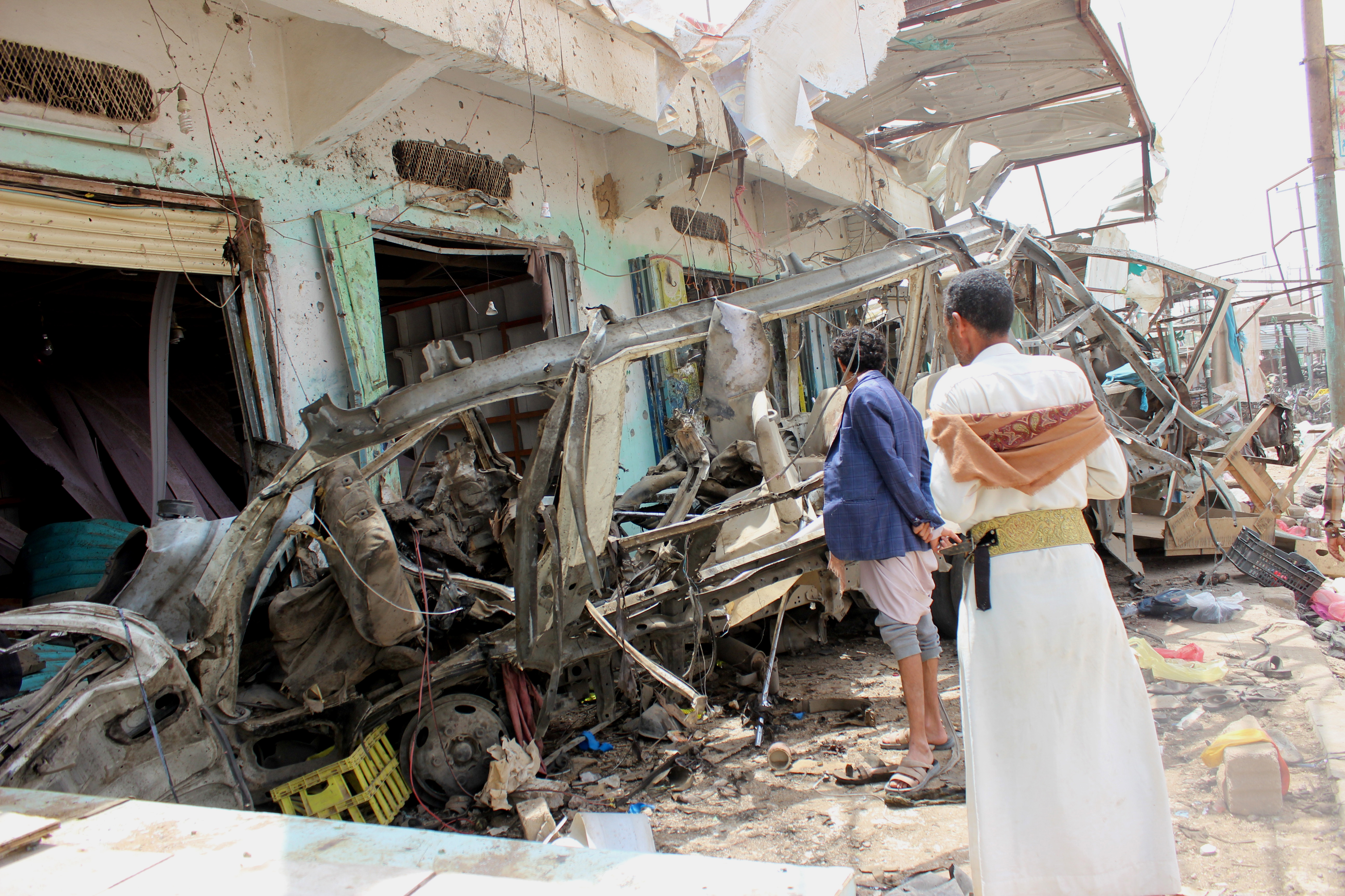 epa06940625 Yemenis inspect a destroyed bus at the site of a Saudi-led airstrike a day after it hit the bus which was carrying children at a market in the northern province of Saada, Yemen, 10 August 2018. According to reports, an alleged Saudi-led airstrike hit a bus carrying children in a market in the northern Yemeni province of Saada, killing at least 50 people, mostly children, and wounding over 70 others.  EPA/STRINGER