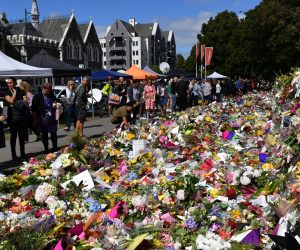 epa07447542 Members of the public looking at flowers at a makeshift memorial at the Botanical Gardens in Christchurch, New Zealand, 19 March 2019. A gunman killed 50 worshippers and injured 50 more at the Al Noor Masjid and Linwood Masjid on 15 March, 28-year-old Australian man, Brenton Tarrant, has appeared in court on 16 March and charged with murder.  EPA/MICK TSIKAS  AUSTRALIA AND NEW ZEALAND OUT