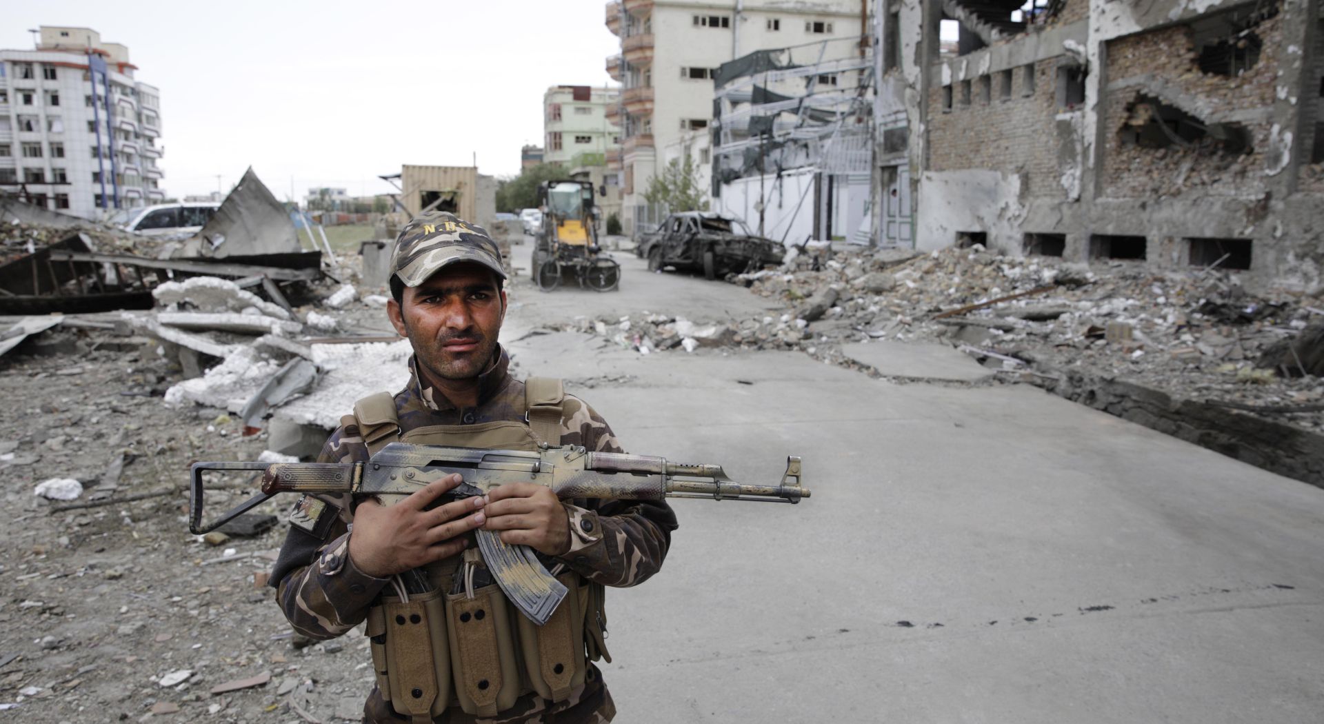 epa07747137 An Afghan security officer stands guard at the site of an explosion a day after a suicide attack followed by a gunfight against the office of Afghan former chief of intelligence and current candidate for first vice president of Ashraf Ghani, in Kabul, Afghanistan, 29 July 2019. According to reports, at least 20 people were killed and 50 others wounded in the incident which targeted the office of Amrullah Saleh.  EPA/HEDAYATULLAH AMID