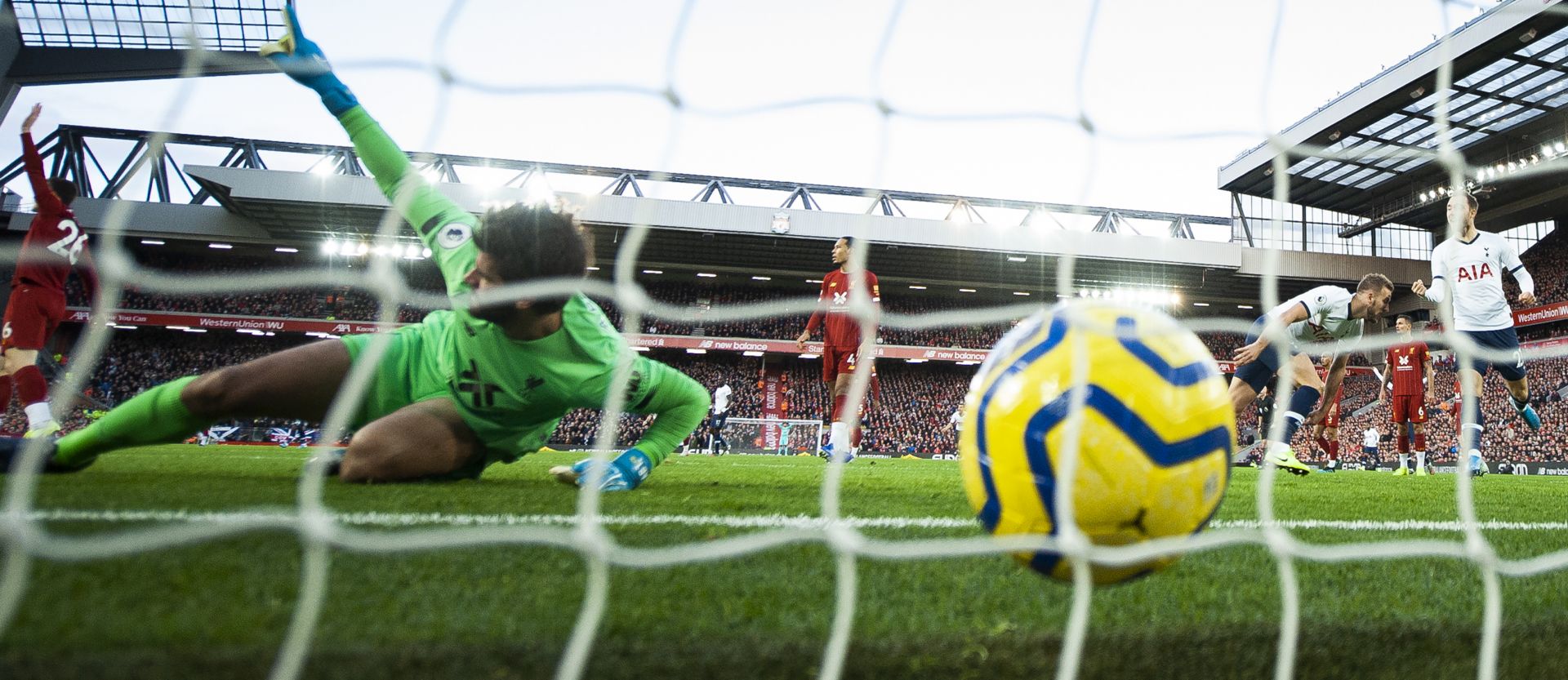 epa07954313 Harry Kane (2R) of Tottenham Hotspur scores opening goal against Liverpool goalkeeper Alisson (L) of Liverpool during the English Premier League game between Liverpool FC and Tottenham Hotspur in Liverpool, Britain, 27 October 2019.  EPA/PETER POWELL EDITORIAL USE ONLY. No use with unauthorized audio, video, data, fixture lists, club/league logos or 'live' services. Online in-match use limited to 120 images, no video emulation. No use in betting, games or single club/league/player publications