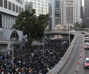 epa08054232 Cars drive by as Hong Kong's pro-democracy protesters (L) take part in a rally organized by the Civil Human Rights Front ahead of the upcoming Human Rights Day, in Hong Kong, China, 08 December 2019. Human Rights Day is celebrated annually across the world on 10 December. Hong Kong is in its sixth month of mass protests, which were originally triggered by a now withdrawn extradition bill, and have since turned into a wider pro-democracy movement.  EPA/JEROME FAVRE