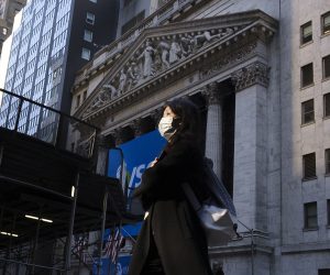 epa08267034 A person wearing a face mask walks past the New York Stock Exchange in New York, New York, USA, 03 March 2020. The previous day, officials announced the city's first known case of the coronavirus in a patient who is a healthcare worker who had recently travelled to Iran, as world financial markets are continuing to react to the spread of the virus.  EPA/JUSTIN LANE