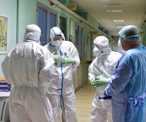 epa08272524 Healthcare professionals wearing protective suits and healthcare masks at work inside the isolation area of the Amedeo di Savoia hospital in Turin, northern Italy, 05 March 2020. Premier Giuseppe Conte said Thursday the cabinet had earmarked 7.5 billion euros to support families and businessesthat are facing the coronavirus emergency.  EPA/Alessandro Di Marco