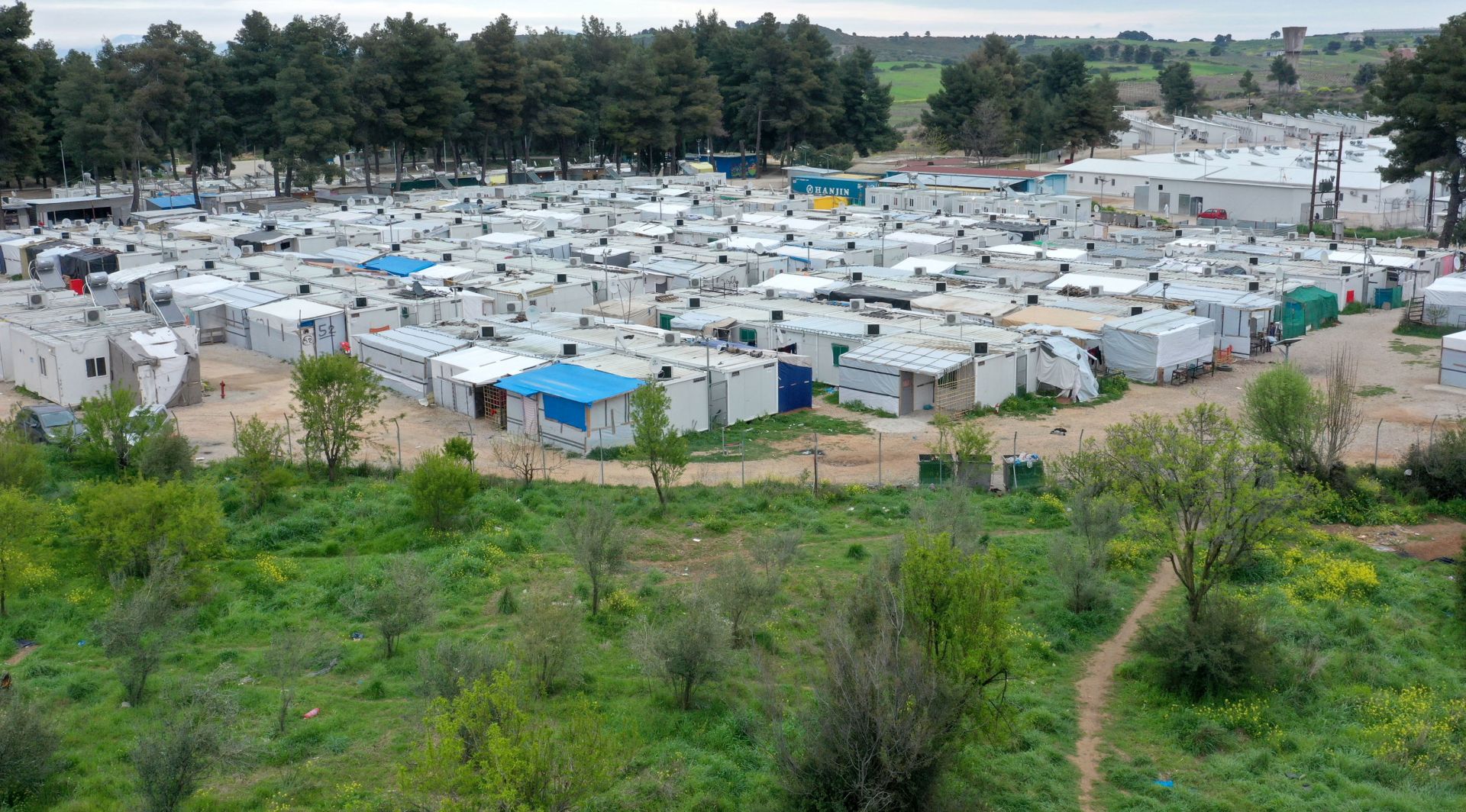 epa08340581 A photograph taken with a drone shows the refugee camp of Ritsona, north of Athens, Greece, 03 April 2020. Deputy Minister for Civil Protection and Crisis Management Nikos Hardalias confirmed on 03 April 2020 that the Ritsona refugee and asylum-seekers facility has been placed on lockdown for the next 14 days as of Thursday morning, after 23 residents so far tested positive for the novel coronavirus.At Ritsona camp lives 2.800 people.  EPA/ANDREAS TSAKNARIDIS