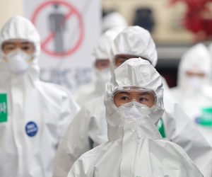 epa08359885 Medical workers in protective gear walk to wards, for COVID-19 patients, before their work shift at Dongsan Hospital in Daegu, South Korea, 13 April 2020.  EPA/YONHAP SOUTH KOREA OUT