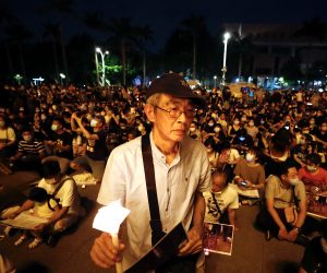 epa08465062 Lam Wing Kee, a former Hong Kong publisher (C) holds a candle as he joins a vigil during the Commemoration of the 31th anniversary of the 1989 Tiananmen Massacre, in Taipei, Taiwan, 04 June 2020. In the early hours of 04 June 1989, Chinese troops cracked down on student protesters at Tiananmen Square in Beijing, leaving many students killed or injured.  EPA/RITCHIE B. TONGO