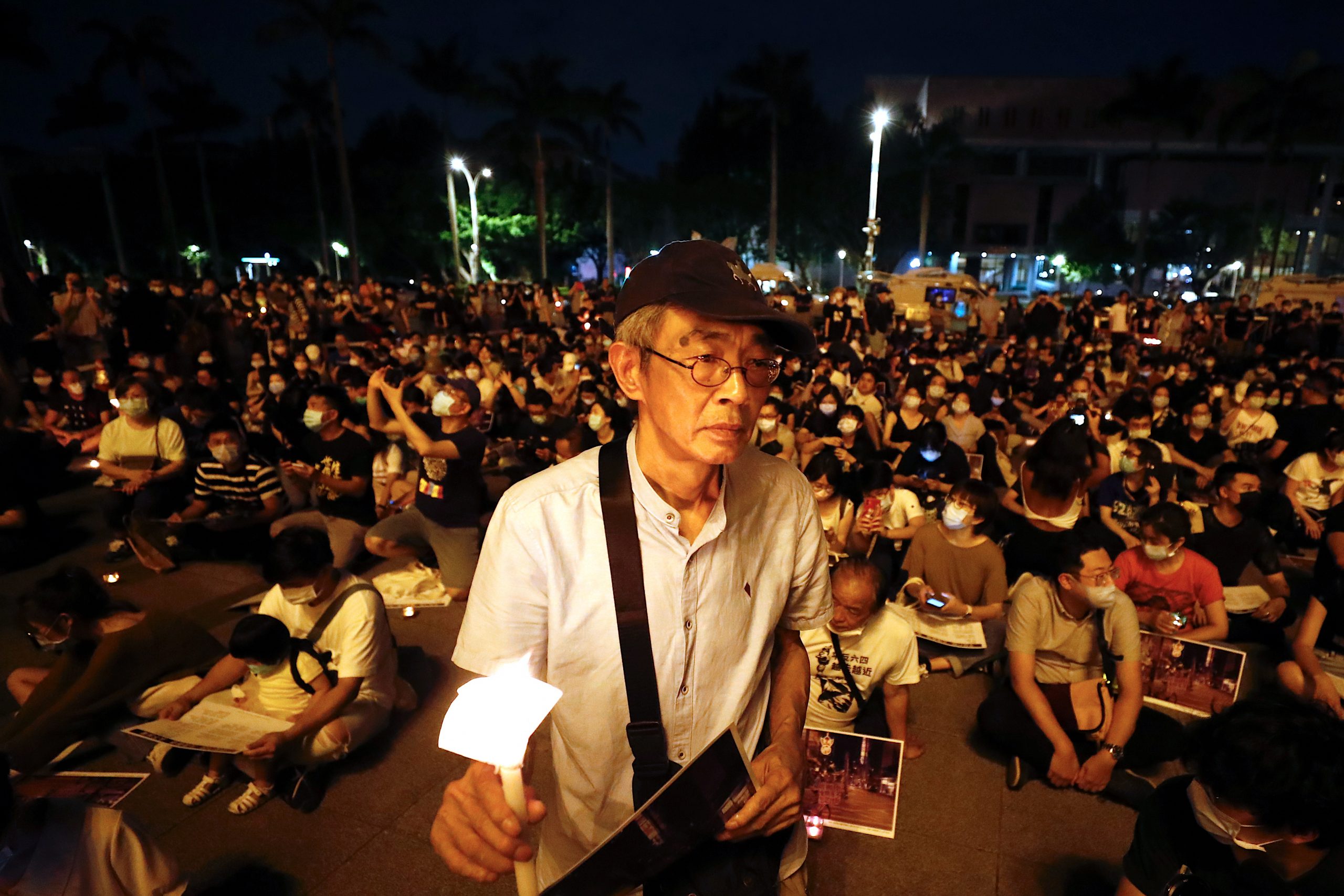 epa08465062 Lam Wing Kee, a former Hong Kong publisher (C) holds a candle as he joins a vigil during the Commemoration of the 31th anniversary of the 1989 Tiananmen Massacre, in Taipei, Taiwan, 04 June 2020. In the early hours of 04 June 1989, Chinese troops cracked down on student protesters at Tiananmen Square in Beijing, leaving many students killed or injured.  EPA/RITCHIE B. TONGO