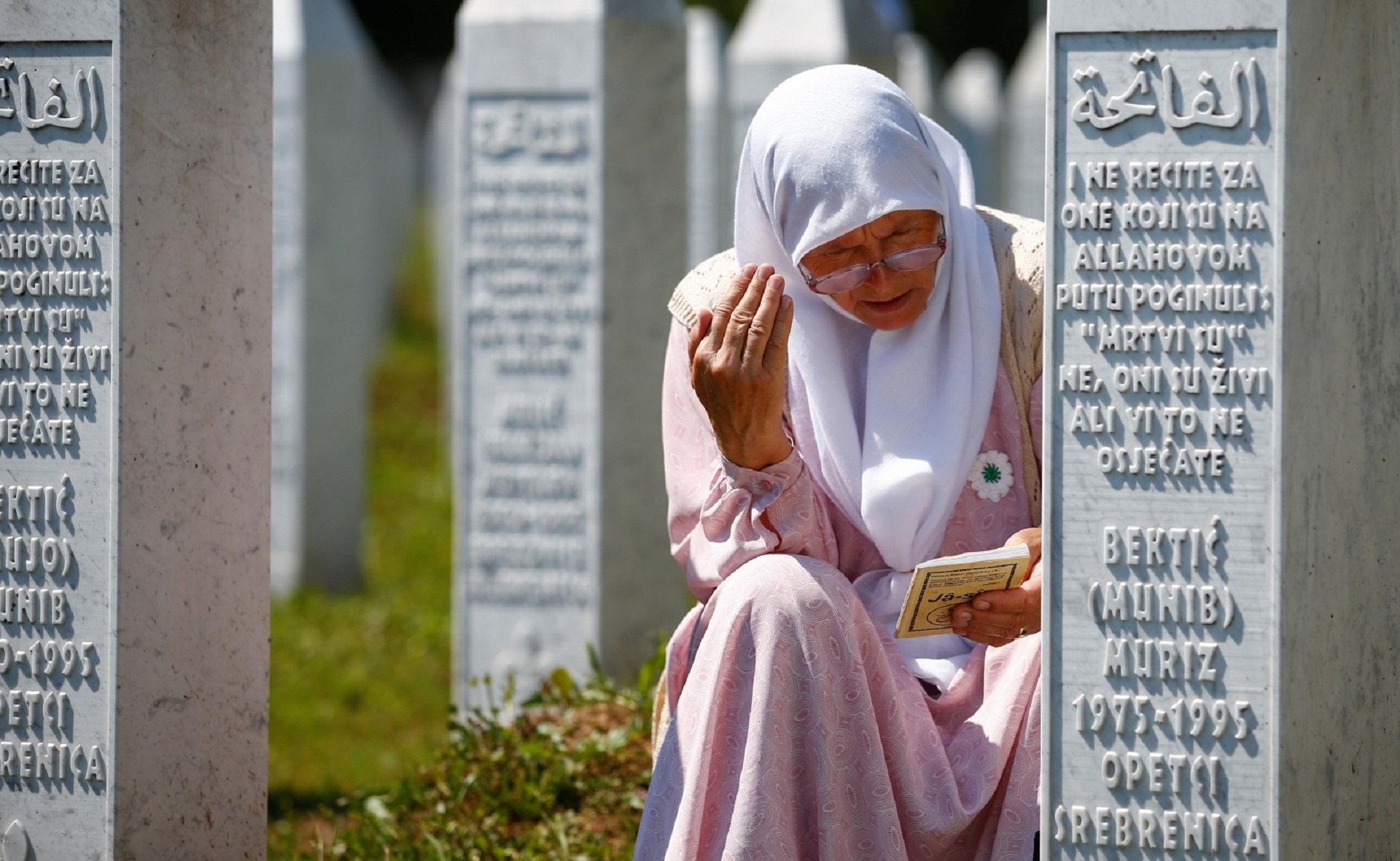 Bosnia and Herzegovina commemorates 25th anniversary of Srebrenica massacre, in Potocari A woman prays at a graveyard, ahead of a mass funeral in Potocari near Srebrenica, Bosnia and Herzegovina July 11, 2020. Bosnia marks the 25th anniversary of the massacre of more than 8,000 Bosnian Muslim men and boys, with many relatives unable to attend due to the coronavirus disease (COVID-19) outbreak. REUTERS/Dado Ruvic DADO RUVIC