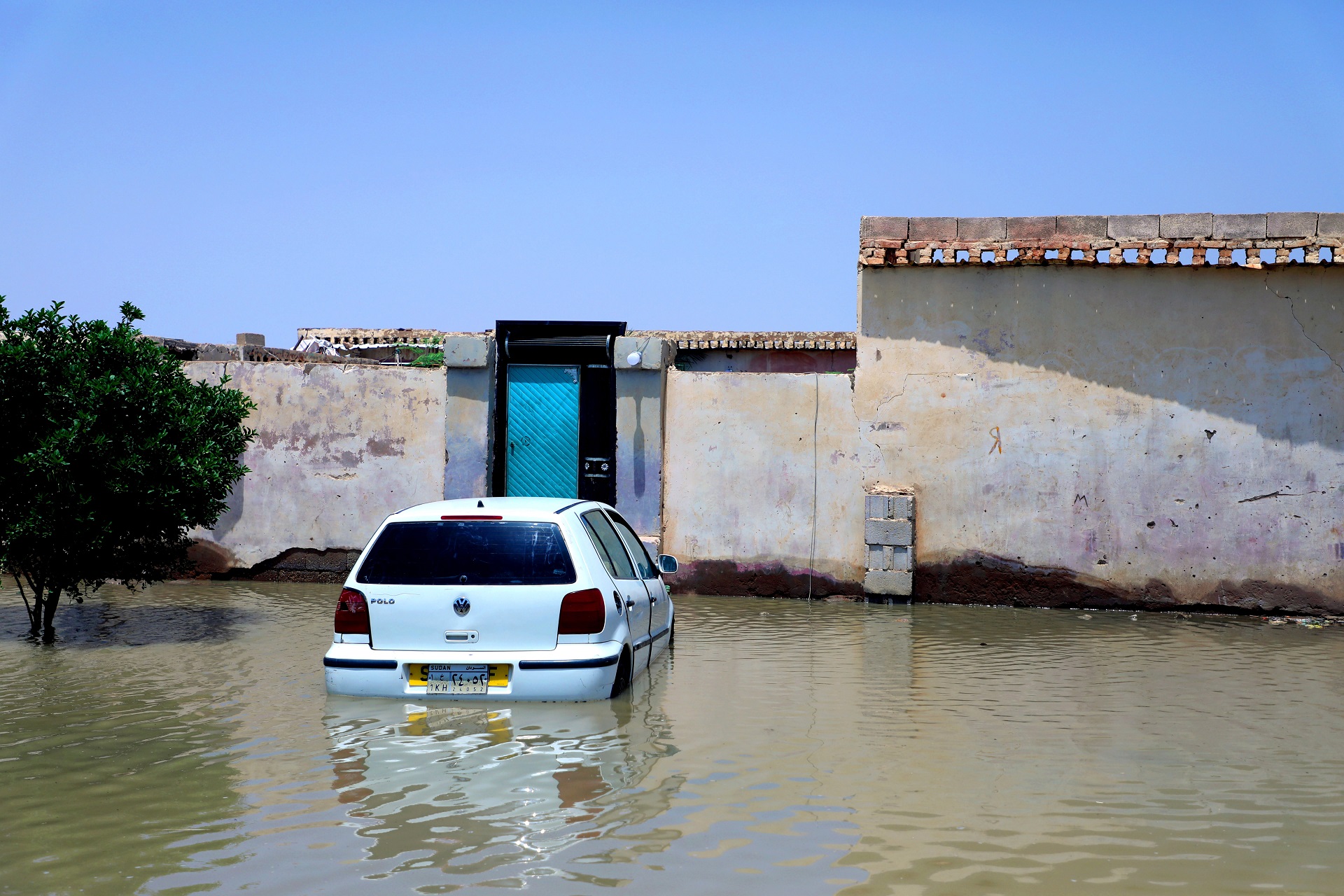 epa08633606 A car is submerged in flood water of the Nile River at al-Kalakla area, south of Khartoum, Sudan, 29 August 2020. According to media reports, at least 86 people reportedly died due to record flood level of the Nile River that also damaged thousands of houses.  EPA/MOHAMMED ABU OBAID