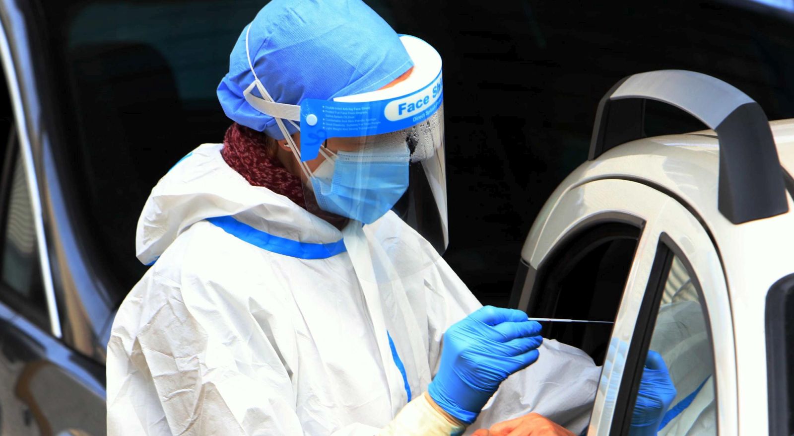 epa08803954 Health workers collect swab samples at a drive-through Covid-19 testing lab outside San Paolo Hospital in Milan, Italy, 07 November 2020. Europe is witnessing a second wave of Covid-19.  EPA/PAOLO SALMOIRAGO