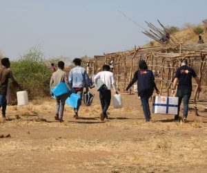 epa08845188 A handout photo made available by the United Nations Population Fund (UNFPA) showing people carrying supplies in Um Raquba camp, Sudan, 18 November 2020 (Issued 26 November 2020). Sudan received some 27,000 refugees escaping the violence in the Tigray region in northern Ethiopia.  EPA/Sufian Abdul-Mouty / UNFPA HANDOUT  HANDOUT EDITORIAL USE ONLY/NO SALES