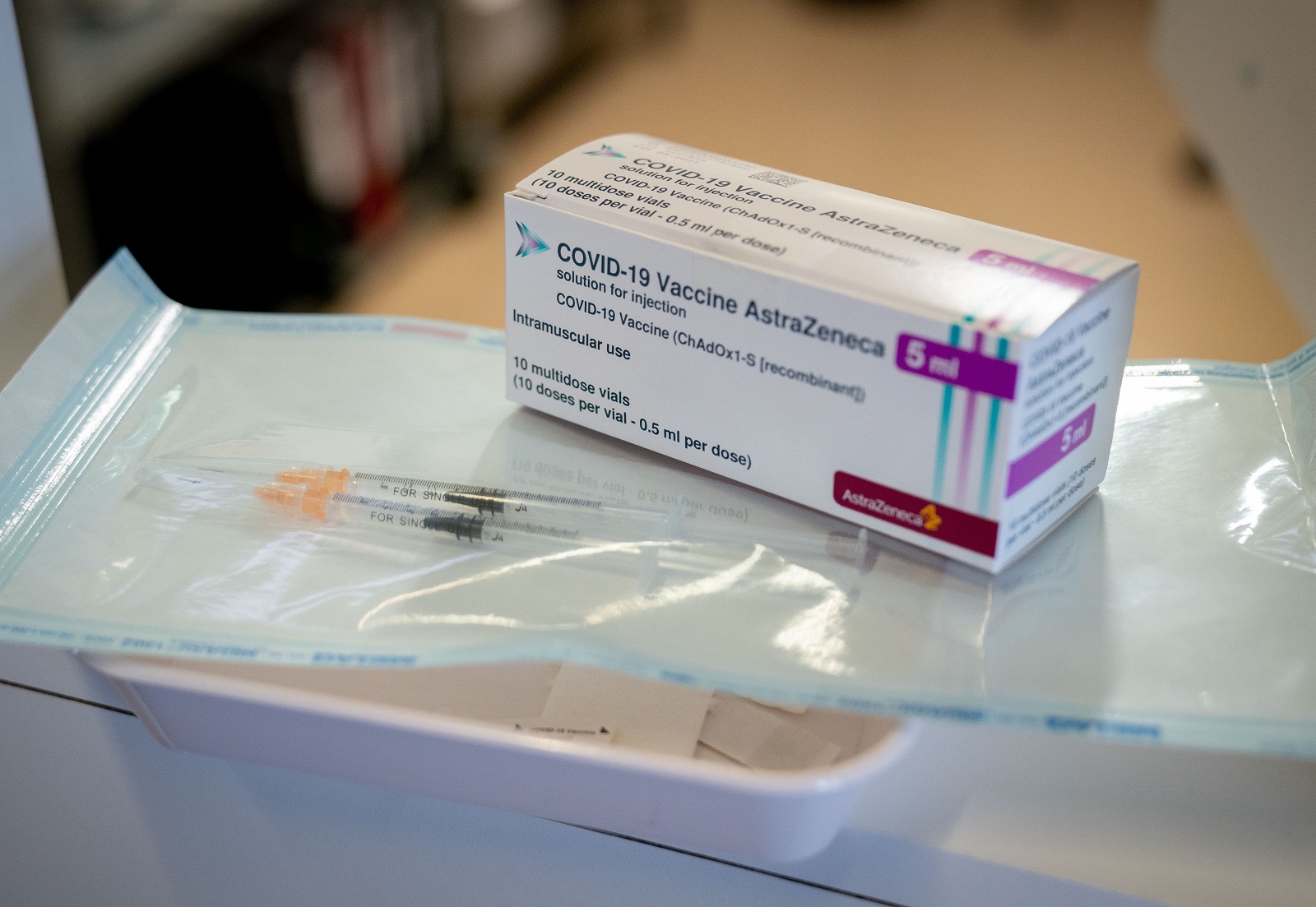 epa09000842 Syringes and a package with the COVID-19 vaccine from AstraZeneca are displayed at the fourth vaccination centre in Berlin at Tegel Airport, Germany, 10 February 2021. At the beginning, mainly nursing staff and medical personnel will be vaccinated against COVID-19 here.  EPA/KAY NIETFELD / POOL