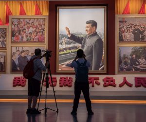 epaselect epa09300254 Media workers stand in front of a picture showing Chinese President Xi Jinping at the newly built Museum of the Communist Party of China during a government-organized media tour, in Beijing, China, 25 June 2021. The museum is scheduled to be open for the public after 01 July, the day when the Chinese Communist Party will mark the 100th anniversary of its founding.  EPA/ROMAN PILIPEY