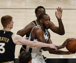 Milwaukee Bucks forward Khris Middleton (22) tries to get past Atlanta Hawks guard Kevin Huerter (3) during the second half of their NBA Eastern Conference Finals playoff series basketball game Saturday, July 3, 2021, in Atlanta. (AP Photo/John Bazemore)