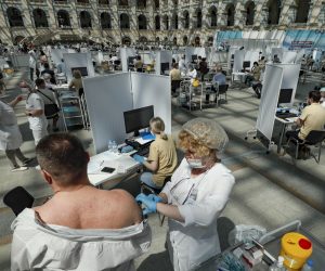 epa09325495 A man receives a shot of Russia's Sputnik V vaccine against COVID-19 disease at a vaccination center in Gostinny Dvor, a huge exhibition place in Moscow in Moscow, Russia, 06 July 2021. Moscow being the epicenter of the new outbreak of the infectious by the new Delta variant. Moscow authorities imposed a ban to serve people without QR-codes confirming vaccination against Covid-19 at public caterings, including people recovering from coronavirus Covid-19 disease within six months before the visit, or negative PCR test taken no earlier than 72 hours before the visit.  EPA/YURI KOCHETKOV