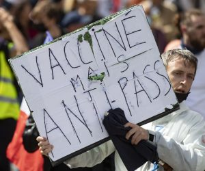 epa09404303 Protesters march during a demonstration against the COVID-19 health pass which grants vaccinated individuals greater ease of access to venues in France, in Paris, France, 07 August 2021. The national enforcement of the 'Health Pass' is expected to take effect on 09 August, after the French Constitutional Council has confirmed the government's law which extend the use of its Vaccinal Passeport (a QR code which proves the bearer has received full vaccination, or been tested negative for Covid in the last 72 hours) to cultural place, transport, and restaurants among other places.  EPA/IAN LANGSDON