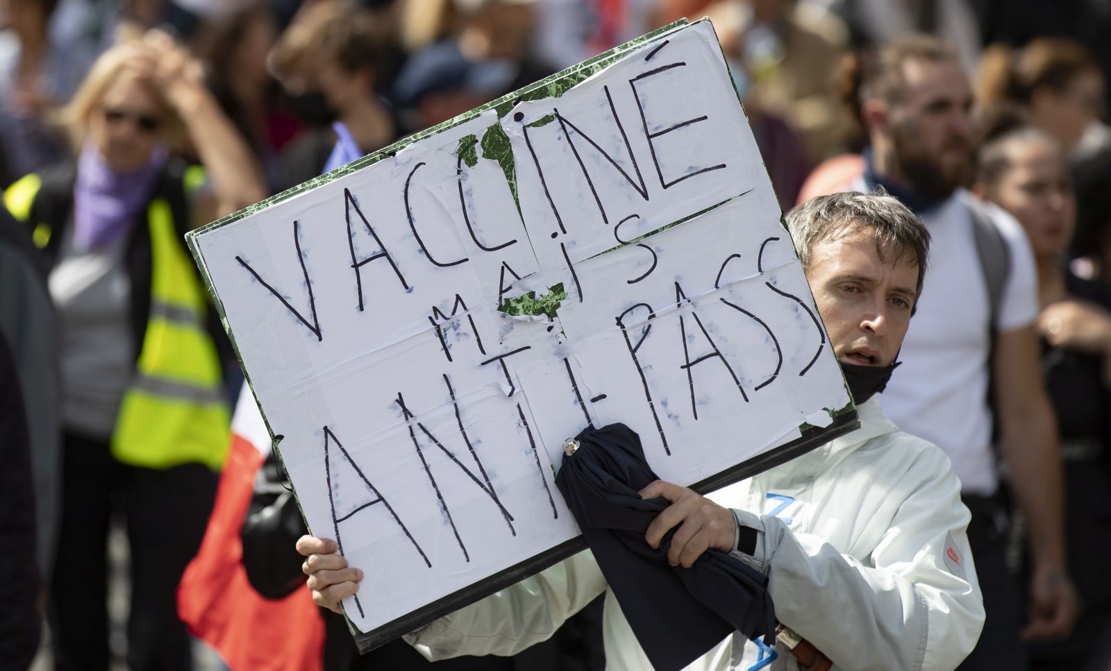 epa09404303 Protesters march during a demonstration against the COVID-19 health pass which grants vaccinated individuals greater ease of access to venues in France, in Paris, France, 07 August 2021. The national enforcement of the 'Health Pass' is expected to take effect on 09 August, after the French Constitutional Council has confirmed the government's law which extend the use of its Vaccinal Passeport (a QR code which proves the bearer has received full vaccination, or been tested negative for Covid in the last 72 hours) to cultural place, transport, and restaurants among other places.  EPA/IAN LANGSDON