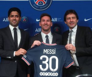 epa09409490 Paris Saint-Germain's president Nasser Al-Khelaifi (L), sports director Leonardo (R) and Argentinian striker Lionel Messi (C) pose with his new PSG jersey after his press conference as part of his official presentation at the Parc des Princes stadium, in Paris, France, 11 August 2021. Messi arrived in Paris on 09 August and signed a contract with French soccer club Paris Saint-Germain.  EPA/CHRISTOPHE PETIT TESSON