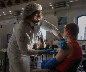 epa09557799 A man receives a shot of Russia's Sputnik V COVID-19 vaccine at a vaccination point at the State Department Store GUM, in Moscow, Russia, 01 November 2021. Authorities approved non-working week from 28 October to 07 November in Russia to curb the fast spreading of coronavirus disease (COVID-19) infections. Restrictions are also put in place during the non-working week, such as the closure of shopping malls, beauty salons, fitness centers and car services. However, pharmacies, hospitals, food stores, museums and theaters will stay open. Cafes and restaurants will only open for takeout and delivery orders.  EPA/YURI KOCHETKOV