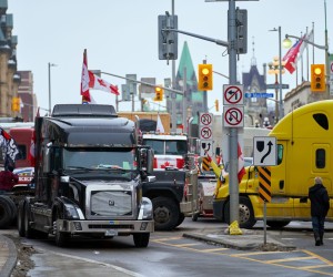 epa09747449 A view of Wellington street as truckers block the streets near the parlement hill during a protest against the vaccine mandates in downtown Ottawa, Ontario, Canada, 11 February 2022. Truckers continue their protest against the mandate by the Canadian government for mandatory vaccines against COVID-19 to be able to return to Canada. A state of emergency was declared in the city of Ottawa on 06 February 2022 and policemen from Ottawa city, Ontario, and the Federal Royal Canadian Mounted Police (RCMP) are deployed on 11 February 2022.  EPA/ANDRE PICHETTE