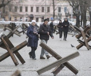 epa09829344 Locals walk on a street between anti-tank Czech hedgehogs in the South Ukrainian city of Odesa, 16 March 2022. On 24 February Russian troops had entered Ukrainian territory in what the Russian president declared a 'special military operation', resulting in fighting and destruction in the country, a huge flow of refugees, and multiple sanctions against Russia.  EPA/STEPAN FRANKO