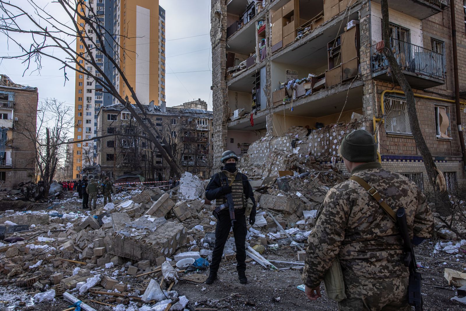 epa09834073 A policeman stands guard next to a destroyed residential building after shelling by the Russian military, in Podilskyi district, in Kyiv, Ukraine, 18 March 2022. One person has been reportedly killed and 19 injured during the shelling that happened in the morning. On 24 February Russian troops had entered Ukrainian territory in what the Russian president declared a 'special military operation', resulting in fighting and destruction in the country, a huge flow of refugees, and multiple sanctions against Russia.  EPA/ROMAN PILIPEY