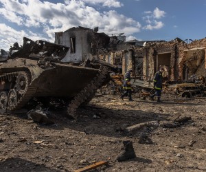 epa09859971 Ukrainian rescue workers walk past destroyed Russian military vehicles next to the railway station where the Russian forces were stationed, in the recaptured by the Ukrainian army Trostyanets town, in Sumy region, Ukraine, 29 March 2022 (issued 30 March 2022). Trostyanets was recaptured by the Ukrainian army after the town was under Russian forces from the first days of the war for over a month. Russian troops entered Ukraine on 24 February prompting the country's president to declare martial law and triggering a series of announcements by Western countries to impose severe economic sanctions on Russia.  EPA/ROMAN PILIPEY