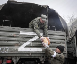 epa09886129 A picture taken during a visit to Mariupol organized by the Russian military shows militias of self-proclaimed DPR unload bread during a distribution of humanitarian aid to local people in Mariupol, Ukraine, 12 April 2022. Some 133,214 people, including two thousand people over the past day, left Mariupol through the gum corridor in the eastern direction, according to the head of the Russian National Defense Control Center. The main battles in the central part of Mariupol are over, said the representative of the people's militia of the self-proclaimed Donetsk People's Republic (DPR). On 24 February Russian troops had entered Ukrainian territory in what the Russian president declared a 'special military operation', resulting in fighting and destruction in the country, a huge flow of refugees, and multiple sanctions against Russia.  EPA/SERGEI ILNITSKY