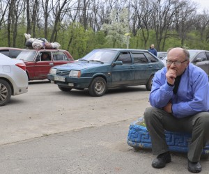 epa09916985 Local people wait on a road as they are evacuating from Ruska Lozova village near Kharkiv, Ukraine, 29 April 2022. People try to leave the conflict area as Ruska Lozova has recently been recaptured by the Ukrainian army from Russian forces in heavy fighting. Russian troops entered Ukraine on 24 February resulting in fighting and destruction in the country and triggering a series of severe economic sanctions on Russia by Western countries.  EPA/SERGEY KOZLOV