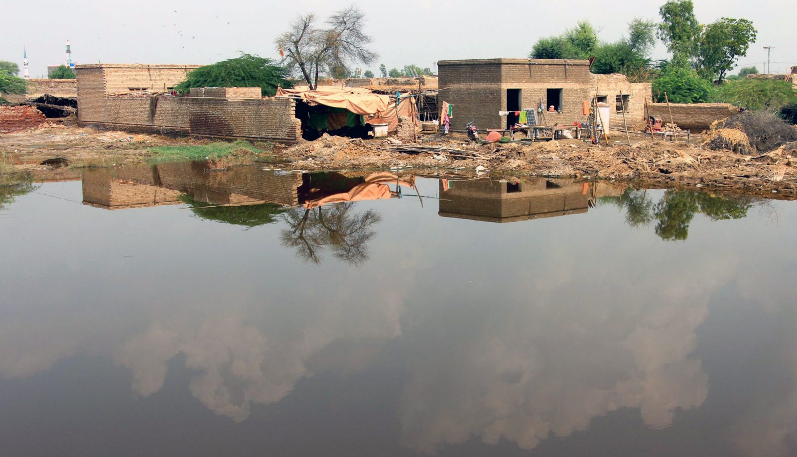 epa10167072 People affected by floods wait for relief in Qambar Shahdadkot, Sindh province, Pakistan, 07 September 2022. According to the National Disaster Management Authority (NDMA), flash floods triggered by heavy monsoon rains have killed over 1200 people across Pakistan since mid-June 2022. More than 33 million people have been affected by floods, the country's climate change minister Sherry Rehman said.  EPA/WAQAR HUSSEIN