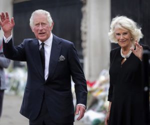 epa10173573 Britain's King Charles III (L) and Camilla, the Queen Consort, look at the floral tributes left outside Buckingham Palace in London, Britain, 09 September 2022. Britain's Queen Elizabeth II died at her Scottish estate, Balmoral Castle, on 08 September 2022. The Prince of Wales became King after the death of his mother and will be known as King Charles III.  EPA/OLIVIER HOSLET