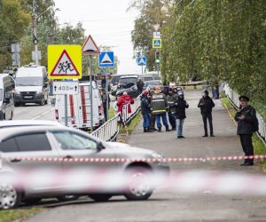 epa10207174 Russian policemen and emergency services members work near the scene of a school shooting at school 88 in Izhevsk, Russia, 26 September 2022. The shooting began during class when an unidentified man in a black suit bursted into a classroom and opened fire on those present. As a result of the attack at school N 88 in Izhevsk, 23 people were injured, including 20 children, said the head of Udmurtia Alexander Brechalo. '13 dead so far, nine of them are children. 23 injured, and 20 of the injured are children,’ he added.  EPA/ANDREY KOROTKOV