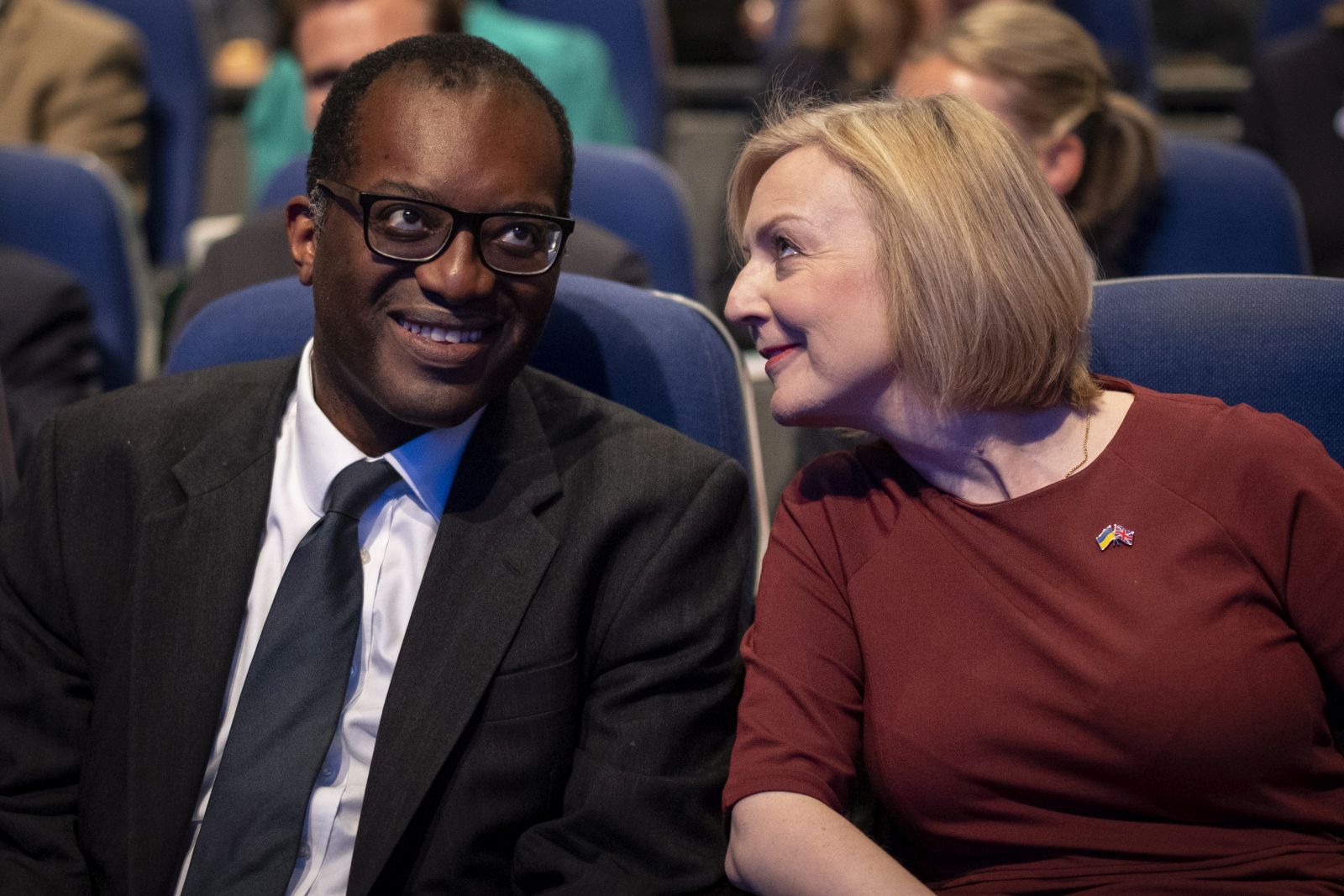 epa10219886 British Prime Minister Liz Truss (R) and Britain's Chancellor of the Exchequer Kwasi Kwarteng (L) chat at the opening session of Conservative Party Conference in Birmingham, Britain, 02 October 2022. Prime Minister Liz Truss admitted they were flaws with the announcement of her 'mini-budget' which led to market turmoils and British pound going historic low against the US dollar.  EPA/TOLGA AKMEN