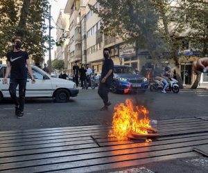 epa10231837 Protesters set a fire as they clash with police during a protest over the death of young Iranian woman Mahsa Amini, who died on 16 September after being arrested in Tehran for not wearing her hijab appropriately, in Tehran, Iran, 09 October 2022. Amini, a 22-year-old Iranian woman, was arrested in Tehran on 13 September by the morality police, a unit responsible for enforcing Iran's strict dress code for women. According to the police, she fell into a coma and died of heart failure, while her family says that she had no prior health conditions. Her death has triggered protests in various areas in Iran and around the world. According to Iran's state news agency IRNA, Iranian President Ebrahim Raisi expressed his sympathy to the family of Amini on a phone call and assured them that her death will be investigated carefully. Chief Justice of Iran Gholam-Hossein Mohseni-Eje'i assured her family that upon its conclusion, the investigation results by the Iranian Legal Medicine Organization will be announced without any special considerations  EPA/STR