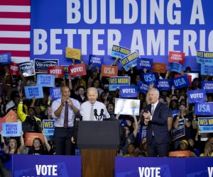 epa10293005 US President Joe Biden (C) takes off his jacket as he begins speaking beside Maryland Democratic gubernatorial candidate Wes Moore (L) and Democratic Senator of Maryland Chris Van Hollen (R), at a rally for the Democratic Party on the eve of election day at Bowie State University in Bowie, Maryland, USA, 07 November 2022. The US midterm elections are held every four years at the midpoint of each presidential term and this year include elections for all 435 seats in the House of Representatives, 35 of the 100 seats in the Senate and 36 of the 50 state governors as well as numerous other local seats and ballot issues.  EPA/MICHAEL REYNOLDS