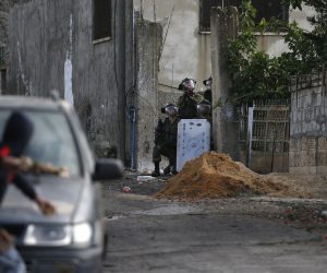 epa10327569 Palestinian protesters throw stones at Israeli troops during clashes after a demonstration against Israel's settlements on the lands of Kafr Qadoum village, near the West Bank city of Nablus, 25 November 2022.  EPA/ALAA BADARNEH