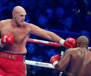 epa10347178 British boxer Tyson Fury (L) in action against British boxer Derek Chisora (R)during the bout between WBC heavyweight champion Tyson Fury and Derek Chisora at the Tottenham Hotspur stadium in London, Britain, 03 December 2022.  EPA/TOLGA AKMEN