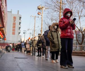 epa10347655 People line up for a PCR test for COVID-19 in Chaoyang district in Beijing, China, 04 December 2022. According to the National Health Commission report on 04 December, a little over 1600 new locally transmitted COVID-19 cases were detected in Beijing. Despite the increase, China loosened COVID-19 curbs as Beijing subway and buses no longer require COVID-19 negative results taken within 48 hours, starting 05 December.  EPA/WU HAO