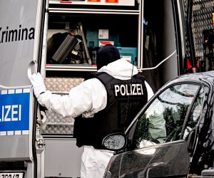 epa10353425 A police officer works during a raid in Berlin, Germany, 07 December 2022. Twenty-five people allegedly affiliated to the so-called Reichs Citizens (Reichsbuerger) movement were arrested in raids across Germany on suspicion of plotting to overthrow the government, a spokesperson for the Federal Prosecutor's office said. A group of far-right and ex-military figures are suspected to have planned to storm the parliament building, the Reichstag, and seize power.  EPA/Filip Singer