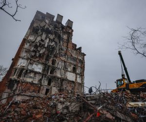 epa10362466 A man walks on the debris of destroyed building in downtown Mariupol, Ukraine, 12 December 2022. Mariupol had seen a long battle for its control between the Ukrainian forces and the Russian army and Russian backed separatist Donetsk People’s Republic (DPR) as well as a siege, the hostilities lasted from February to the end of May 2022 killing thousands of people and destroying most of the city in the process. According to the DPR government which took control after May 2022, more than five thousand builders are currently working in Mariupol, they expect the city to be completely rebuilt in three years' time.  EPA/SERGEI ILNITSKY