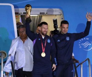 epa10374424 Lionel Messi (C) of the Argentina national soccer team descends a plane with the trophy of Qatar 2022 World Cup accompanied by head coach Lionel Scaloni (R), upon ther arrival to the International Airport of Ezeiza, some 22km of Buenos Aires, Argentina, 20 December 2022.  EPA/RAUL MARTINEZ