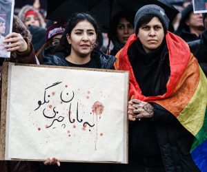 epa10396059 Protesters hold a cardboard in Persian (Farsi) reading in English: ‘don’t tell mama’ which is a quote from one of the executed Iranian protesters in front of the Brandenburg Gate during a rally to commemorate the victims of the Iranian regime in Berlin, Germany, 08 January 2023. Protesters gathered to commemorate the third anniversary of the downing of the Ukraine International Airlines Flight PS752 by Iranian armed forces on 08 January 2020 near Tehran, killing all 176 people aboard. As well as demanding a stop to the ongoing executions in Iran.  EPA/CLEMENS BILAN