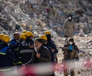 epa10472649 A man reacts while soldiers and rescue helpers gather at the site of collapsed buildings after a powerful earthquake, in Hatay, Turkey, 17 February 2023. Almost 44,000 people have died and thousands more are injured after two major earthquakes struck southern Turkey and northern Syria on 06 February. Authorities fear the death toll will keep climbing as rescuers look for survivors across the region.  EPA/MARTIN DIVISEK