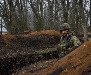 epa10492896 A Ukrainian serviceman of the 68th Separate Jager Infantry Brigade "Oleksa Dovbush" walks in a trench on a frontline position at an undisclosed location in the Donetsk region, eastern Ukraine, 26 February 2023. Russian troops entered Ukraine on 24 February 2022 starting a conflict that has provoked destruction and a humanitarian crisis.  EPA/OLEG PETRASYUK