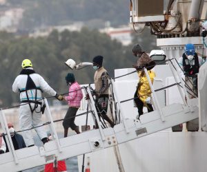 epa10514926 Social and health workers carry out the disembarkation operations of the first migrants rescued at sea, at a port in Reggio Calabria, southern Italy, 11 March 2023.  EPA/MARCO COSTANTINO