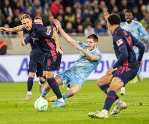 epa10526916 Bratislava's Giorgi Chakvetadze (C) in action against Basel's Michael Lang (L) during the UEFA Conference League round of 16 second leg soccer match between SK Slovan Bratislava and  FC Basel 1893 in Bratislava, Slovakia, 16 March 2023.  EPA/JAKUB GAVLAK